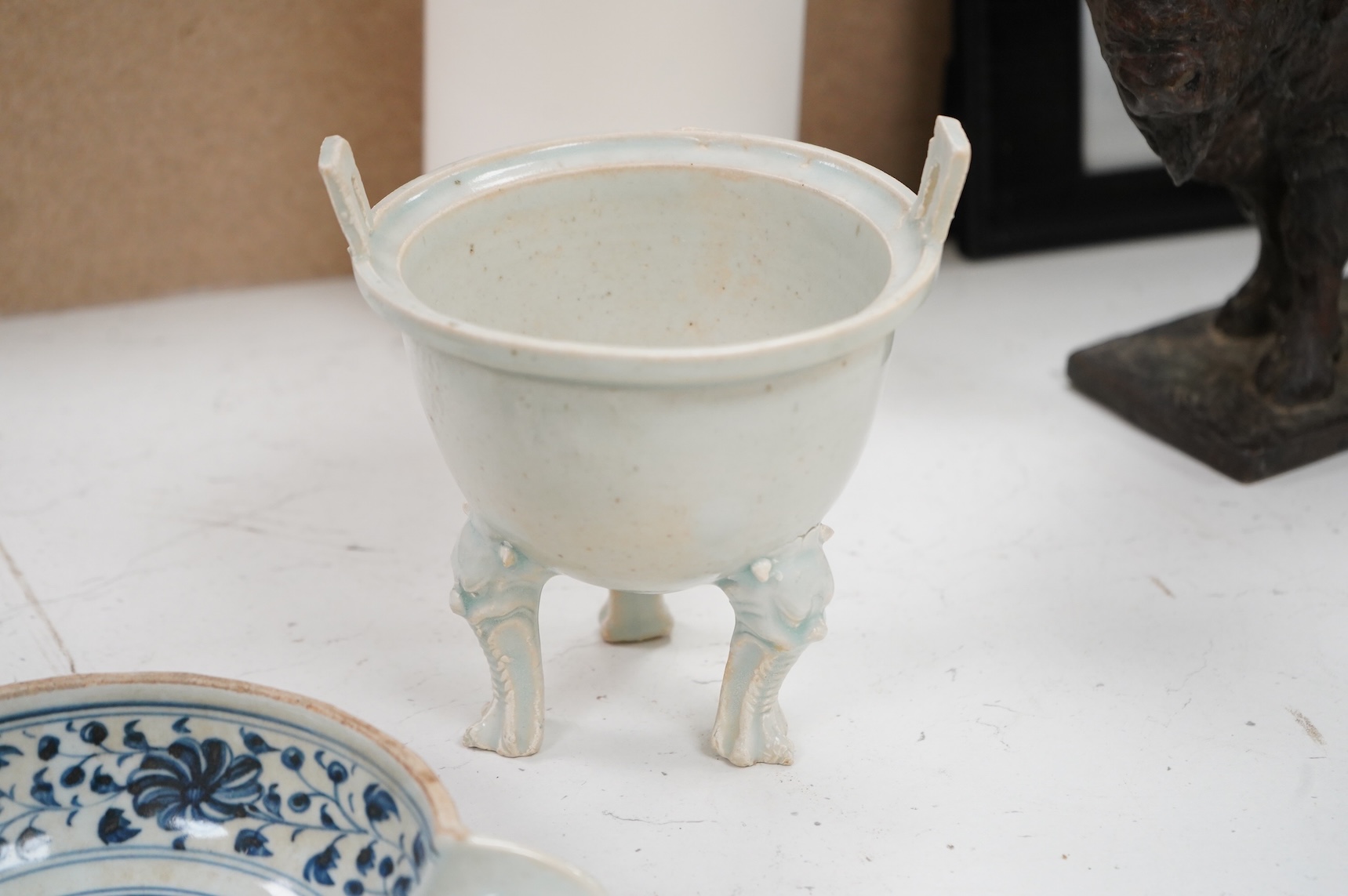 A Chinese three footed censer and a blue and white pouring bowl, largest 15cm high